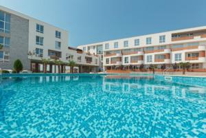 a large swimming pool in front of a building at Apartments in Las Brisas in Burgas