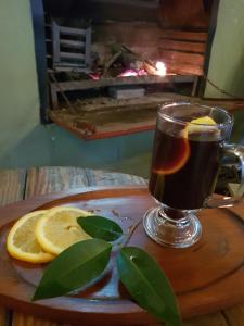 a cup of tea and lemon slices on a wooden table at Little Rock Resort in Ladybrand