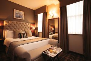 a hotel room with a bed and a table with food on it at The Vermont Hotel & Vermont Aparthotel in Newcastle upon Tyne