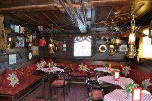 a restaurant with tables and chairs and a couch at Den Röda Båten in Stockholm