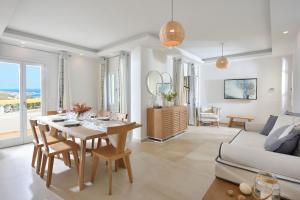 a living room with a table and a couch at Jenny's Summer Houses in Platis Yialos Mykonos