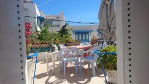 a balcony with a table and chairs and plants at Cosy Duplex" Sidi Bou Said " in Sidi Bou Saïd