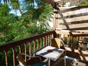 a wooden table and chairs on a balcony at casarno grande el guro in Calera