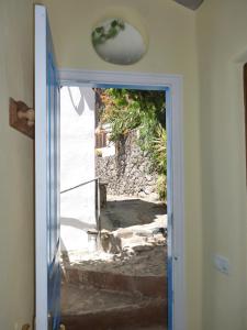 an open door with a view of a stone wall at casarno pequena el guro in Calera