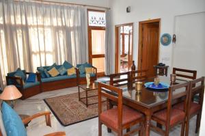 a living room with a table and a couch at Sandy's Homestay in Jammu