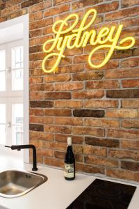 a brick wall with a sign that reads kitchen at Bliss Apartments Sydney in Poznań