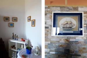 a living room with a stone wall and a painting of a ship at Marvelous Sea View Eco Apt in Ammouliani