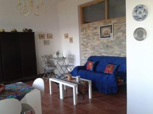 a living room with a blue couch and a table at Marvelous Sea View Eco Apt in Ammouliani