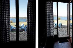 two views of a patio with a table and chairs at Marvelous Sea View Eco Apt in Ammouliani