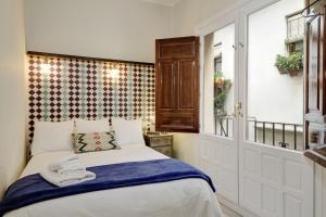 Postel nebo postele na pokoji v ubytování Apartamentos Mirador Alhambra