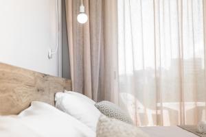 a bedroom with a bed and a window with curtains at RVHotels Nieves Mar in L'Escala