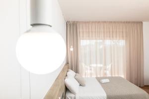 a bedroom with a bed and a window at RVHotels Nieves Mar in L'Escala
