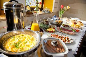 a table with a buffet of food on a table at Zamek Pod Brzozami, Wynajem Pokoi in Krynica Zdrój