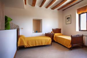 a room with two beds and a window at La Casona de Pitillas in Pitillas