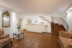 a living room with a staircase and a couch at Landhaus Carstens in Timmendorfer Strand