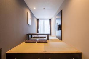 a room with two beds sitting on a table at HOTEL R9 Kujukuri "ex Casual Resort COFF Ichinomiya" in Ichinomiya