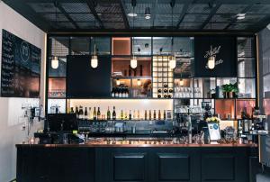 a bar in a restaurant with a lot of bottles at Hotel No13 in Bergen