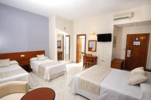 Postel nebo postele na pokoji v ubytování Hotel Complejo Los Rosales