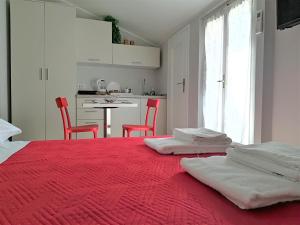 ein Schlafzimmer mit einem roten Bett mit zwei roten Stühlen in der Unterkunft Sottoriva dream in Verona