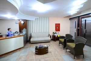 a woman sitting at a counter in a room at Hotel Imperial in Mossoró