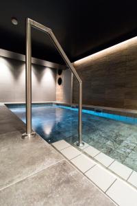 a swimming pool with blue water in a building at Best Western Plus Hus 57 in Ängelholm