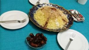 a table with plates of food with a cake on it at Azur Tafraout in Tafraoute