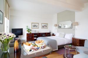 a hotel room with a bed and a table with food at Montmartre Residence in Paris