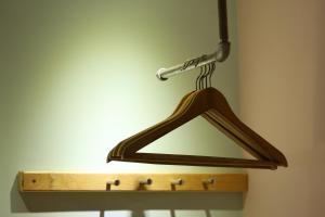 a wooden hanger hanging on a wall with a light at Huxi B&B in Ji'an