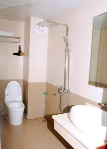a bathroom with a shower and a toilet and a sink at Sunflower Hotel in Ninh Binh