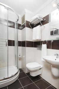 a bathroom with a shower toilet and a sink at Hotel Expocity Istanbul in Avcılar