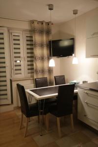 a kitchen with a dining room table and chairs at Eden Apartment Łucka in Warsaw