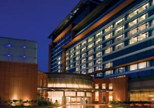 a large building with a building at night at The Oterra in Bengaluru