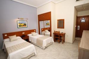Postel nebo postele na pokoji v ubytování Hotel Complejo Los Rosales