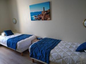 Postel nebo postele na pokoji v ubytování Hotel De La Mer