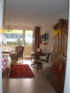 a living room with a couch and a table at Heart of Davos apartments in Davos