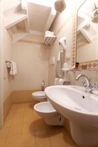 a white toilet sitting next to a sink in a bathroom at Locanda Il Maestrale in Monterosso al Mare
