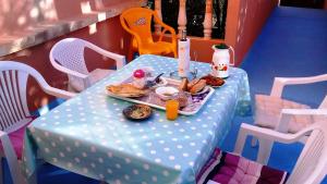 a blue table with a plate of food on it at Azur Tafraout in Tafraoute