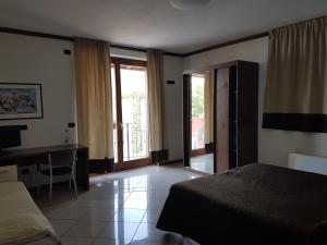 Postel nebo postele na pokoji v ubytování Hotel & Residence La Sibilla Cusiana