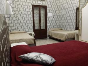 Posteľ alebo postele v izbe v ubytovaní Hotel Ca' Nobile Corner