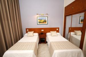 Postel nebo postele na pokoji v ubytování Hotel Complejo Los Rosales