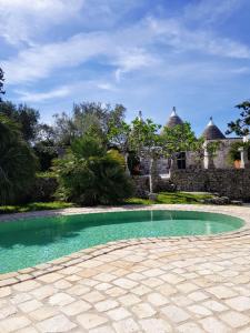 einem Pool vor einem Steingebäude in der Unterkunft Rocca Giulia in Ostuni