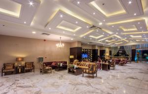 a lobby with couches and chairs and a chandelier at Al Muhaidb Residence Al JAWAZAT 1 - Economic in Riyadh
