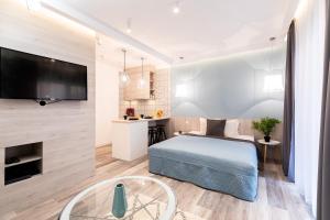 a bedroom with a bed and a tv on a wall at SWU Broadway in Budapest