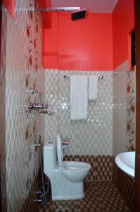 a bathroom with a toilet and a sink at Panorama Guest House in Nagarkot +79 photos