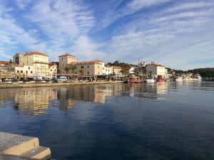 a large body of water with buildings and houses at Seaside Villa Katrine in Banjol