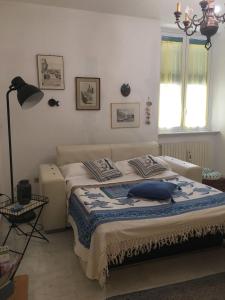 a bedroom with a bed with blue pillows on it at La Casa Dell'Amore Perfetto in Genova