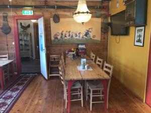 a dining room with a wooden table and chairs at Eidfjord Hytter in Eidfjord