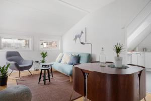 a living room with a blue couch and a table at LS Apartments in Bergen