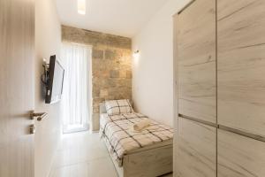 a bedroom with a bed in a room with a window at Apartment DeLux in Split
