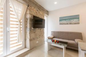 a living room with a couch and a window at Apartment DeLux in Split